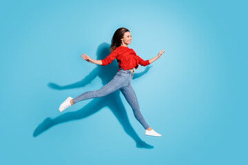 Fototapeta na wymiar Full length photo of lady jump high moving like ballerina graceful motion shadow isolated blue color background