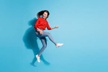 Full length photo of funky crazy lady jump flight play imaginary guitar musician isolated blue...