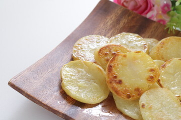homemade fried potato on wooden plate with copy space