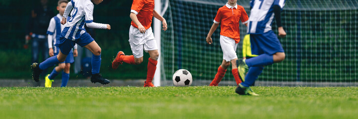 Horizontal Image of Football Match. Boys Kicking Soccer Game. Footballers Running and Compete in Children Football League