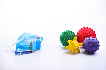 medical mask, syringe and medical ampoules. Children's toys represent viruses. stop inscription. virus protection concept. colorful bright isolated spiky ball toy