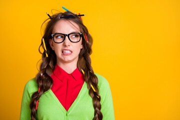 Photo of geek teenager girl messy hairstyle look copyspace disgust isolated yellow color background