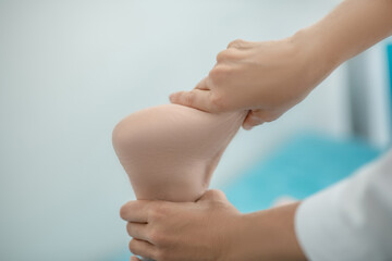 Close up of human hands doing foot massage