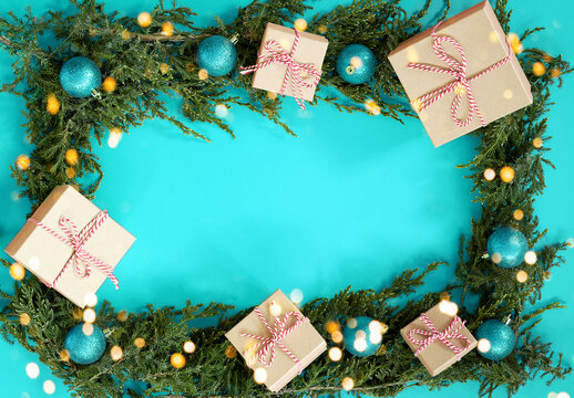Flat lay new year cristmas craft boxes, aqua blue balls and pine tree on aqua blue. High quality photo