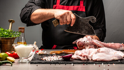 Chef cuts the carcass rabbit raw meat, using meat cleaver, Hands of a chef preparing a rabbit. Long banner format