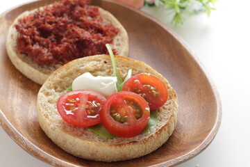 corned beef and cherry tomato in English muffin sandwich