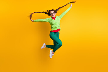 Fototapeta na wymiar Full length body size view of nice funky crazy carefree childish cheerful girl jumping having fun isolated bright yellow color background
