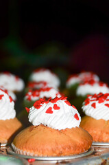 Close up of cupcake with icing and small heart sprinkle. Dessert for holidays and valentine's day. Copy space.