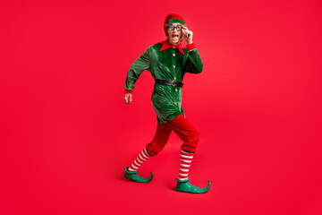 Full length profile side photo of crazy elf walk fast copyspace wear green costume isolated on...