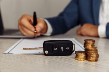 Purchase agreement for a car with contract, stamp and key close-up. Concept for sale car.