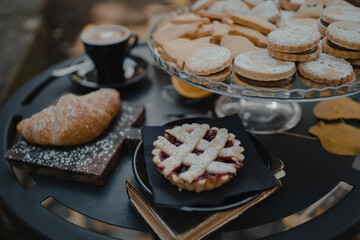 Italian breakfast, cappuccino and mixed desserts with orange juice on the table