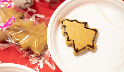 Gingerbread in the shape of Christmas tree with glaze decor. Decorating gingerbreads, step 4. Preparing for the Christmas or New Year concept. Xmas at home concept. 
