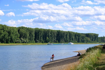 July 09 2020 - Germersheim/Germany: people swimming in rhine river and are relaxing