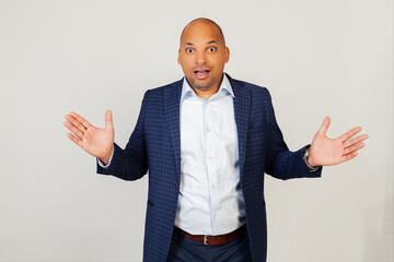 Portrait of surprised young african american guy businessman, celebrating crazy and overwhelmed with success with raised hands and open eyes, screaming excited. Winner concept