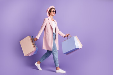 Profile full size photo of positive pretty girl go hold purchases wear glasses coat jeans shoes...