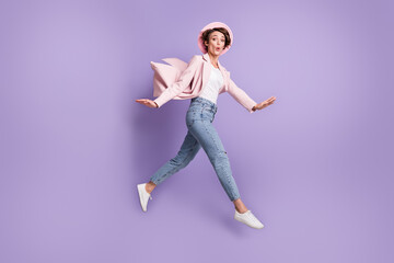 Profile photo of excited crazy young woman jumping flying dress trendy outerwear isolated on violet...