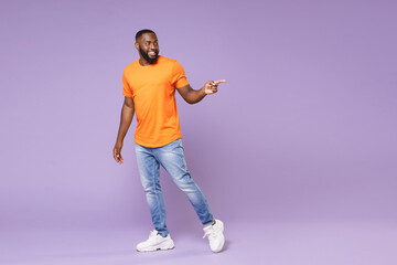 Full length of smiling cheerful young african american man 20s wearing basic casual orange t-shirt...