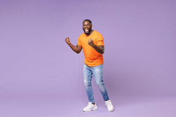Full length of screaming young african american man 20s wearing basic casual orange t-shirt...