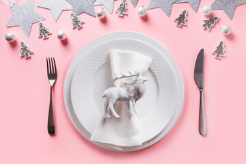 Christmas white winter table setting with reindeer on pink background. Top view.