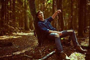 dreamy guy relaxing in nature