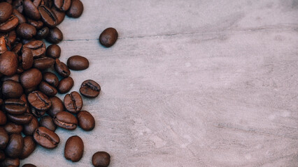 Coffee beans stacked on a gray textured old background. space for text, copy space, for advertisements, flyers