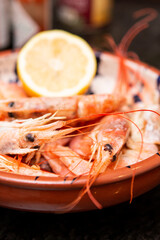 freshly cooked prawns served with lemon