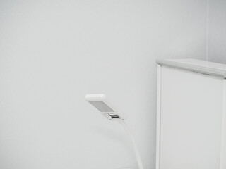 Geometric square white medical lamp with glass in doctor's office. Light interier background. Detail