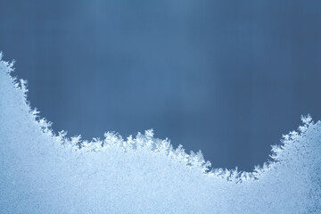 Frosty pattern on the blue glass with copy space (abstract)