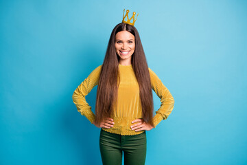 Photo portrait of smiling woman wearing golden crown isolated on pastel blue colored background