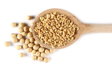 Raw soybeans with soy flakes pile in wooden spoon isolated on white background, top view