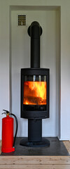 red fire extinguisher standing infront of a fireplace in livingroom