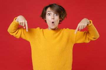 Amazed surprised shocked young brunette woman 20s wearing casual yellow sweater standing pointing...