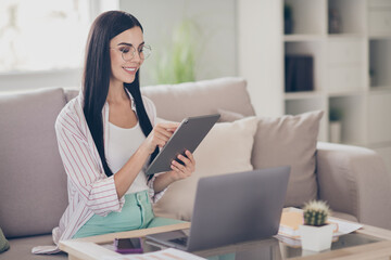 Photo of young business woman hold tablet typing touchscreen wear glasses shirt in home workstation...
