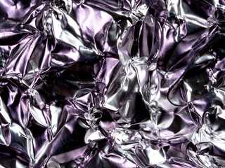 Crumpled silver foil sheet, texture of shiny crumpled piece foil