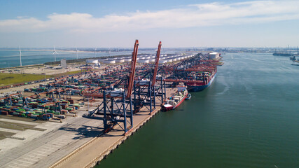Rotterdam harbor big ship with containers and cranes on dock