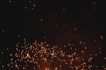 close up of sparks from fire, sparks on black background, extravaganza of fire, magic with sparks.