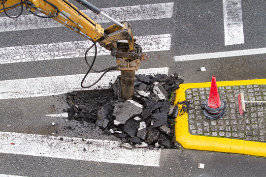 Construction Machine Jackhammer Breaking Asphalt Of The Road