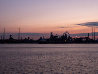 Industrial steel company with smoking towers in the early morning