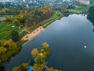 River in a forest Park with a beach on an autumn cloudy day, photo from a drone.
