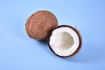 Coconut and one cracked on blue background