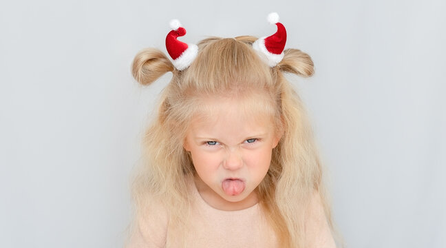 Little girl portrait with Santa hats instead bull horns