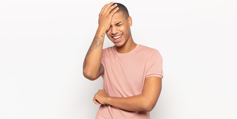 young black man laughing and slapping forehead like saying d’oh! I forgot or that was a stupid...