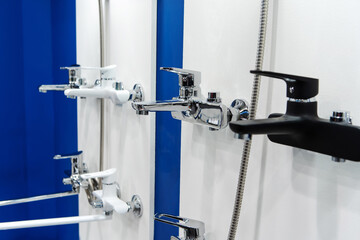 Bathroom taps on a counter in a plumbing store. Household goods trade