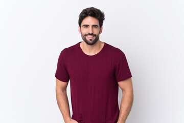 Fototapeta premium Young handsome man with beard over isolated white background laughing