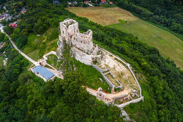 Csesznek, Hungary - Aerial drone view of the hilltop Castle of Csesznek and Csesznek city at sunset...