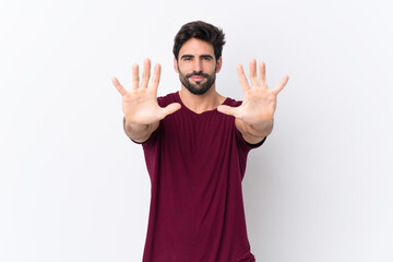 Young handsome man with beard over isolated white background counting ten with fingers