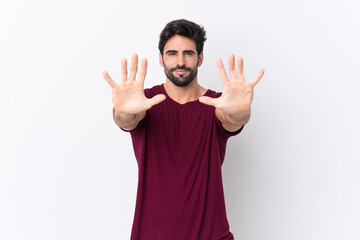 Fototapeta premium Young handsome man with beard over isolated white background counting ten with fingers