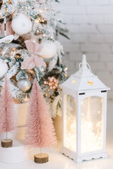 Christmas gifts under fir tree. Vintage New Year decorations. gift boxes and white lantern. Christmas mood. Celebrating of New Year