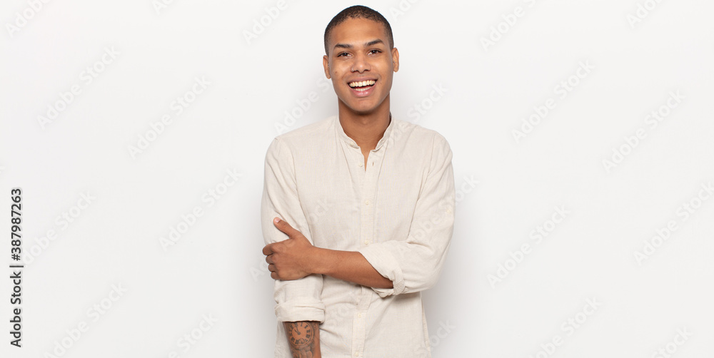 Sticker young black man laughing shyly and cheerfully, with a friendly and positive but insecure attitude