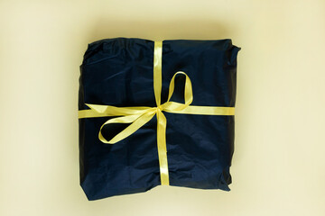 Black Present Box With Gold Ribbon. Flat lay